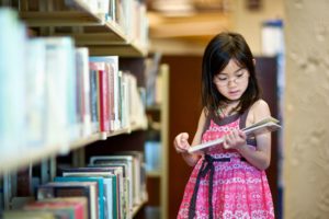 Girl reading at the library